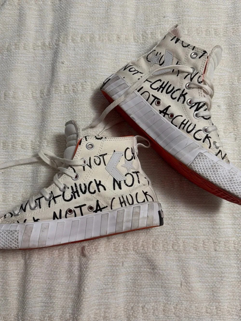 Converse High Top Sneakers in White with Red Sole and Black Graphic Text